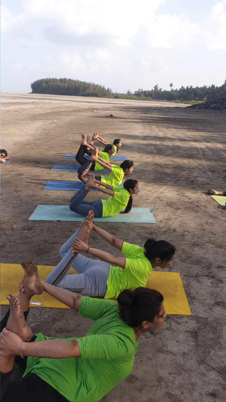 New Age Yoga Institute students practising together on the beach